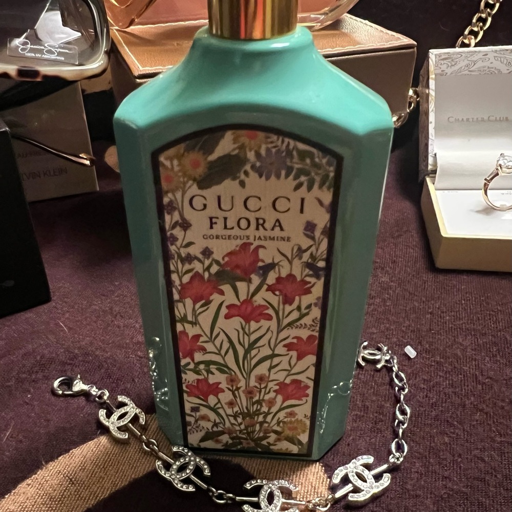 Gucci floral decorative bottle in aqua and gold accents